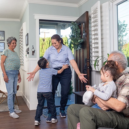 A child and mom hug in front of grandparents that are secure in retirement thanks to ZoneChoice Income Annuity from TruStage™