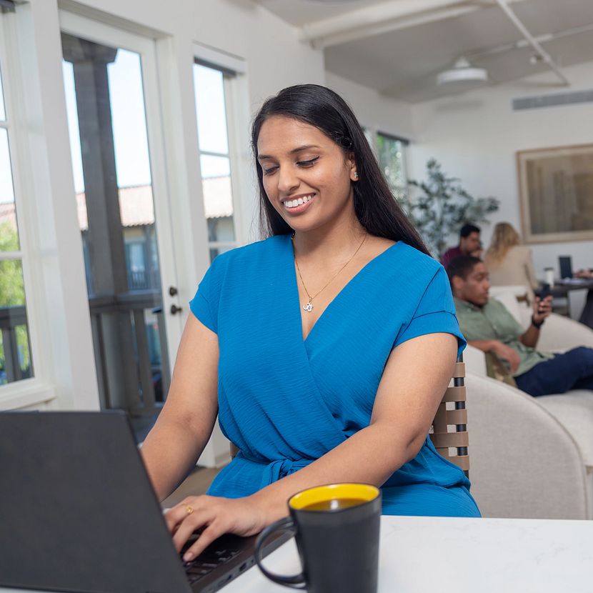 A woman researches TruStage workplace solutions on her laptop
