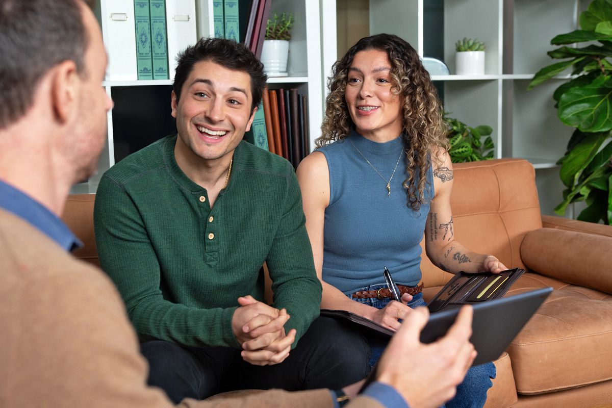 A man and woman sit with a financial professional discussing how TruStage is building brighter financial futures.