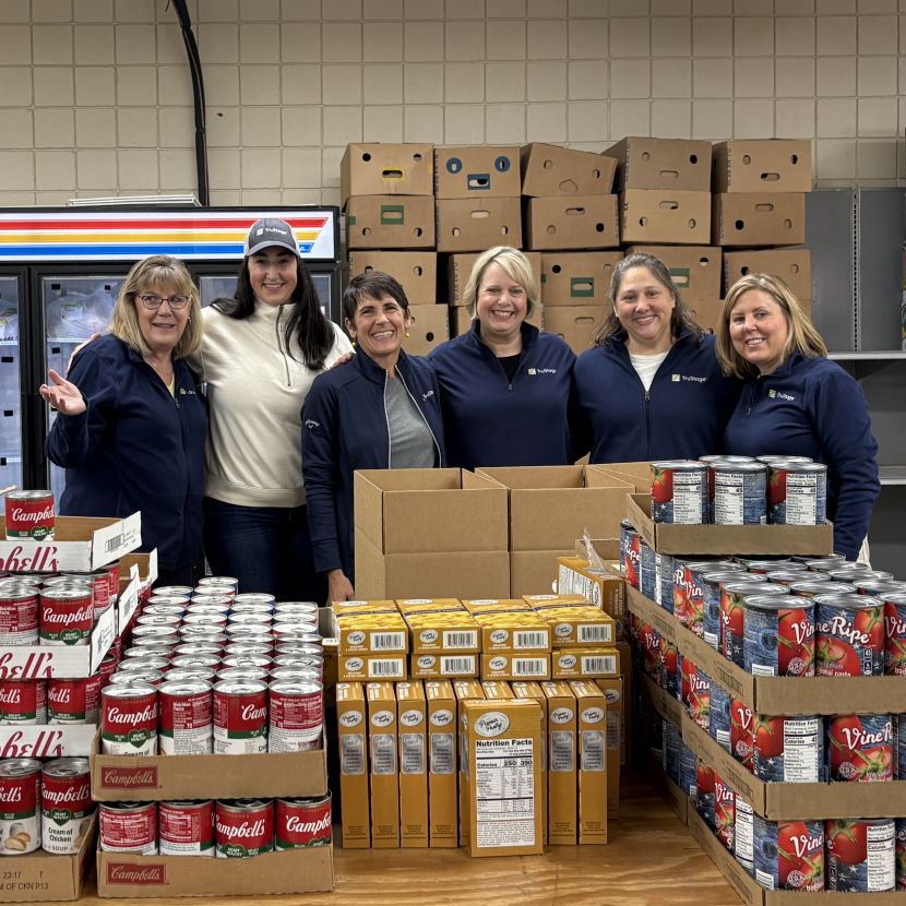 TruStage employees organize food items to be donated to those in need.