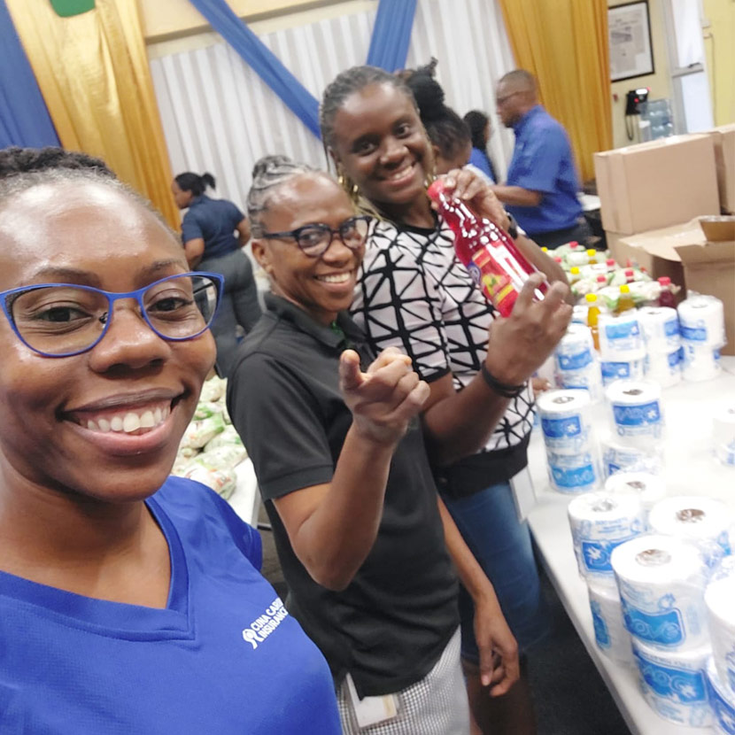 Three sales team members work together to help residents of Clarendon and St. Elizabeth after a Hurricane Beryl in Jamaica.