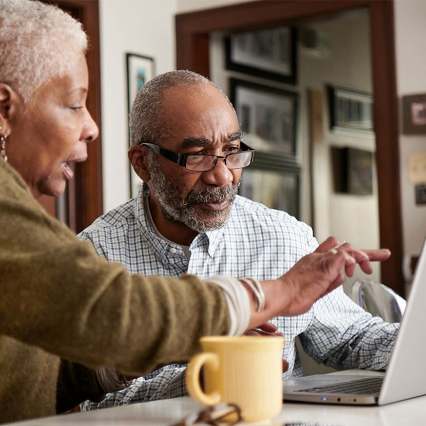 Two people looking at a laptop