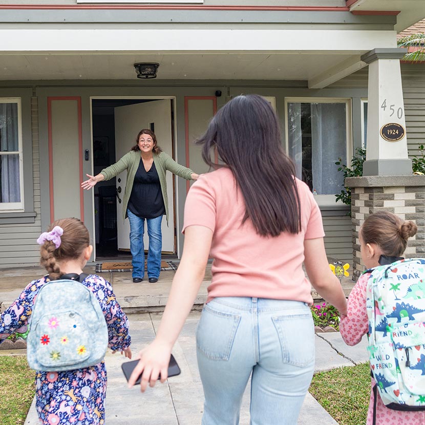 A grandma greets some family at her doorstep as she's better protected in retirement by TruStage Future Income Annuity