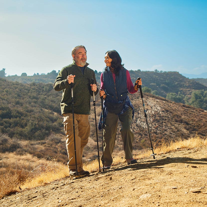 A man and woman on an outdoor hike discuss their retirement which includes ZoneChoice Annuity from TruStage