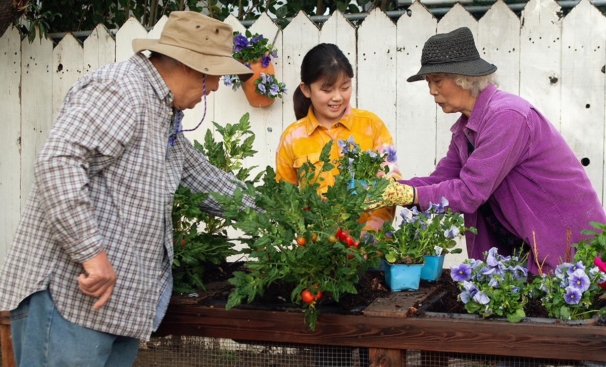 Three retirees tend to their community flower garden are secure in their retirement thanks to TruStage™ ZoneChoice Annuity