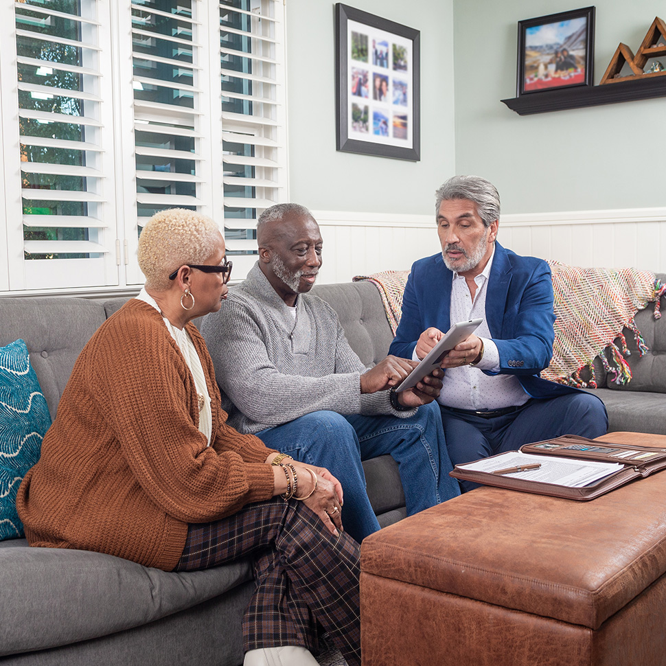 A man and woman meeting with a financial advisor to look over TruStage annuities.