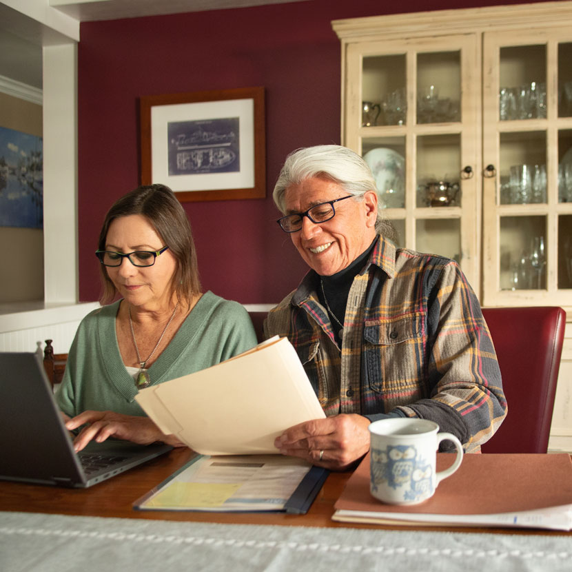 A couple looking over TruStage business protection resources together