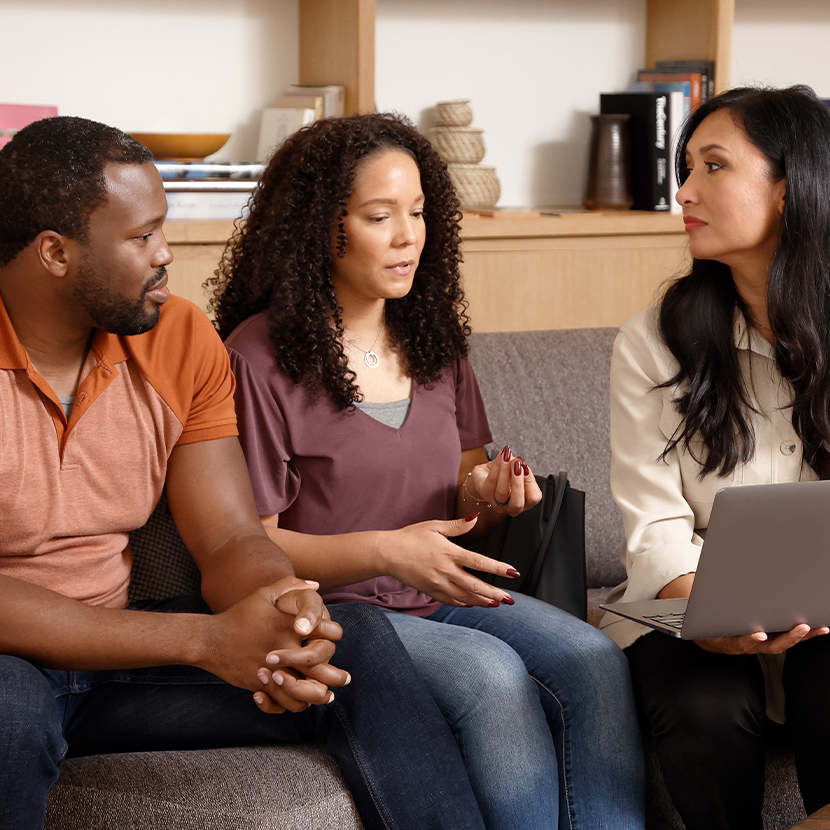 Man and two women discussing business