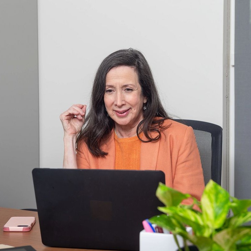 Trustage professional woman looking over life insurance policy.