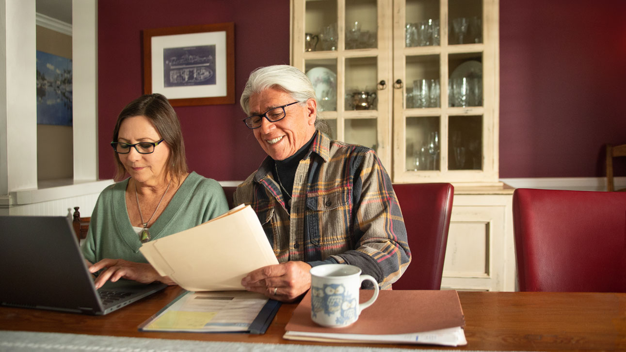 A couple looking over TruStage business protection resources together