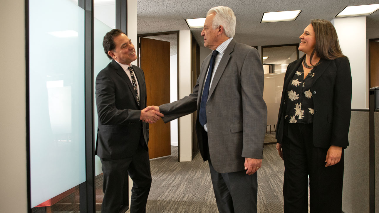 Group of people in an office discussing TruStage speaker resources.