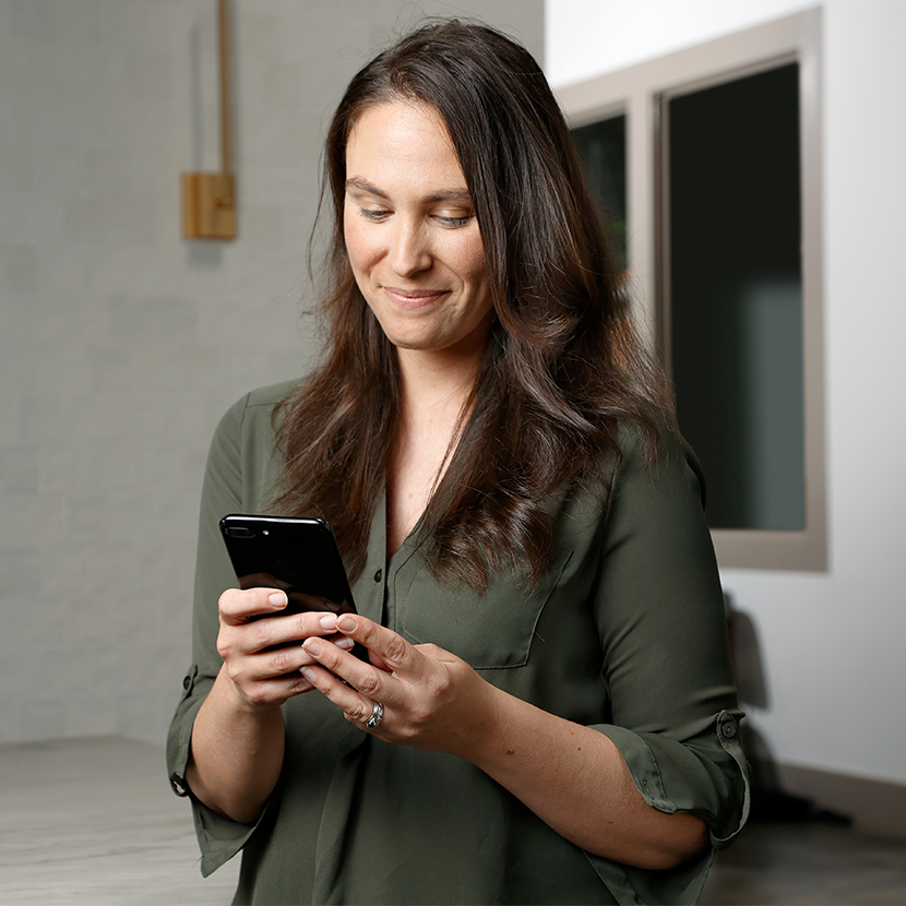 A TruStage rep responds to a credit union inquiry on her phone.