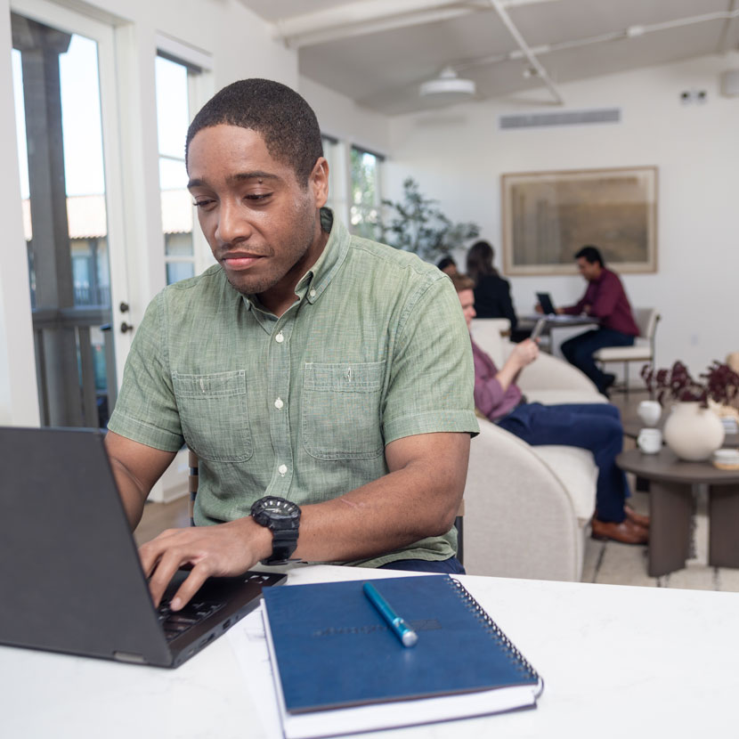 A man researches TruStage integrated payment protection on his laptop