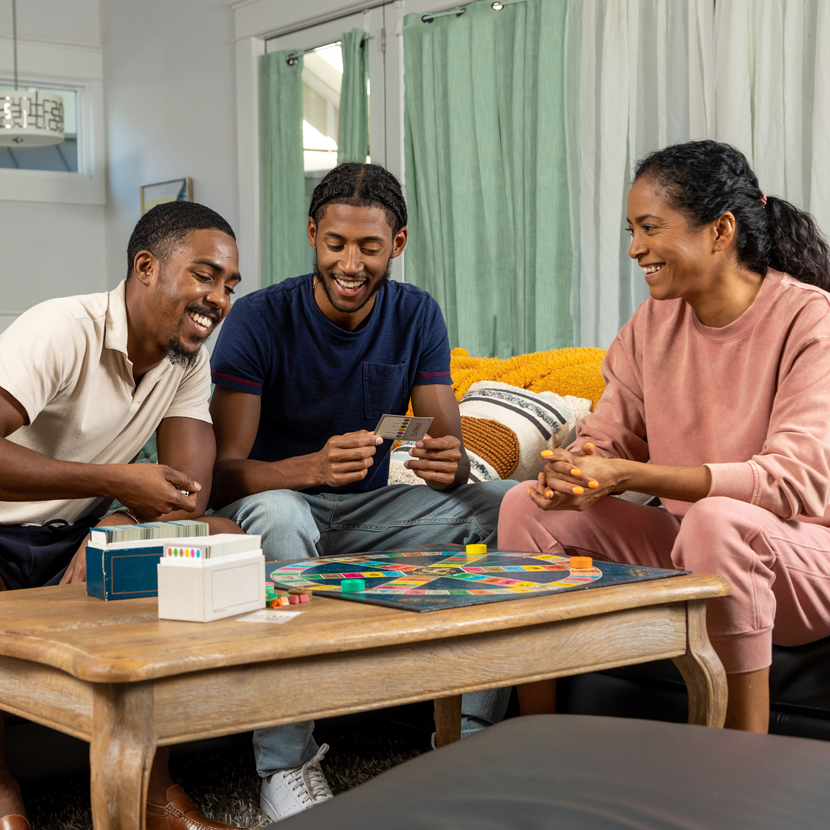 Employees and friends playing a board game