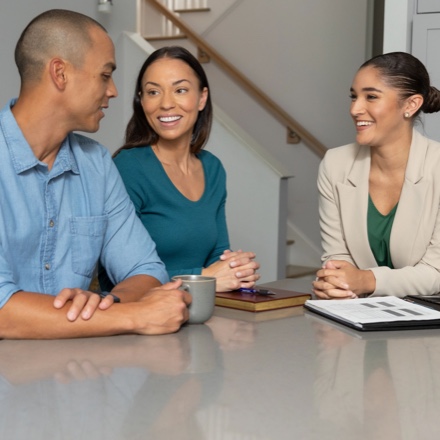 A young couple discussing their finances with their financial advisor.