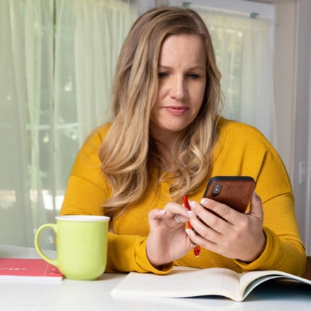 Women checks her TruStage online account with her mobile device