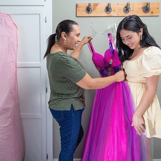 A mother and daughter look at a quinceanera dress.