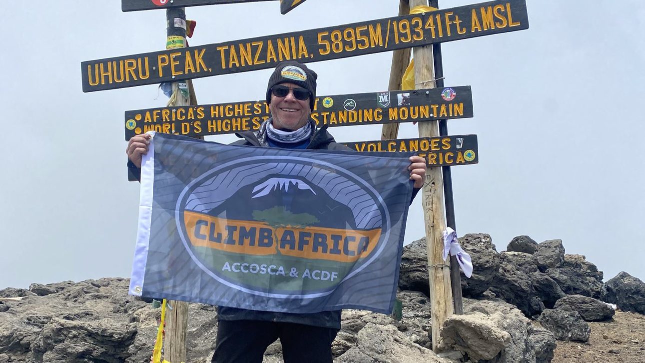 Man mountain climbing in Tanzania, Africa