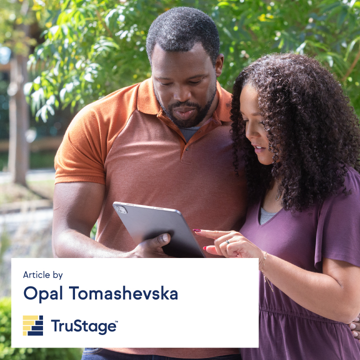 A Black couple looking at their financial report on a tablet