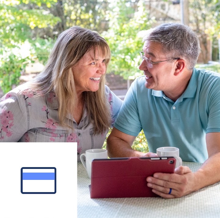 A couple reviews their credit and finances while sitting at their table