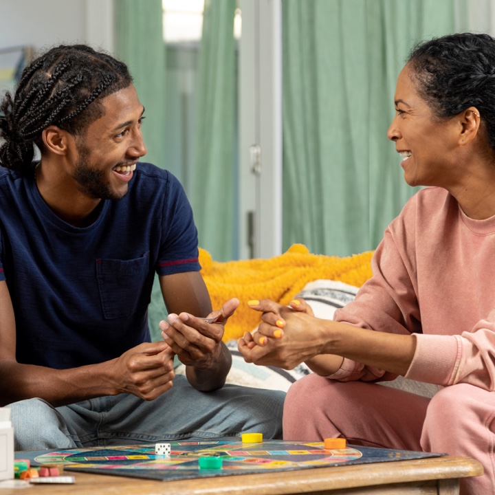 A couple enjoys a board game, less worried about the future thanks to their life insurance policy