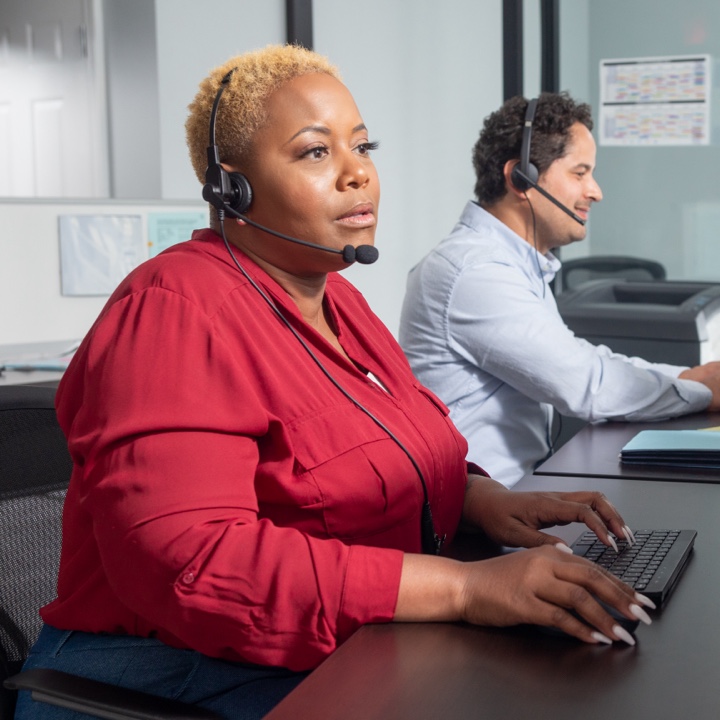 An insurance claims rep helping a customer over the phone