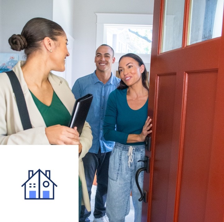 A couple greets their realtor at the front door