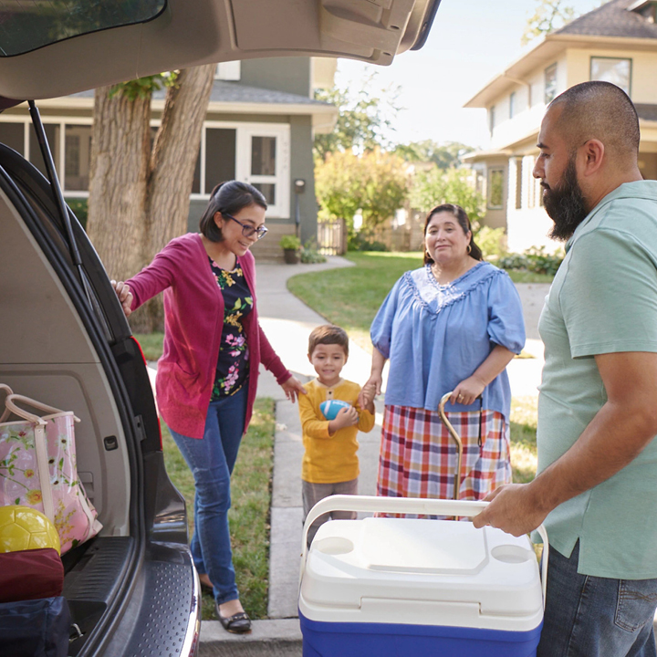 A family packing up their vehicle for a road trip