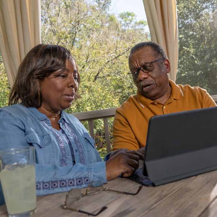 A couple discussing their insurance coverage on their patio