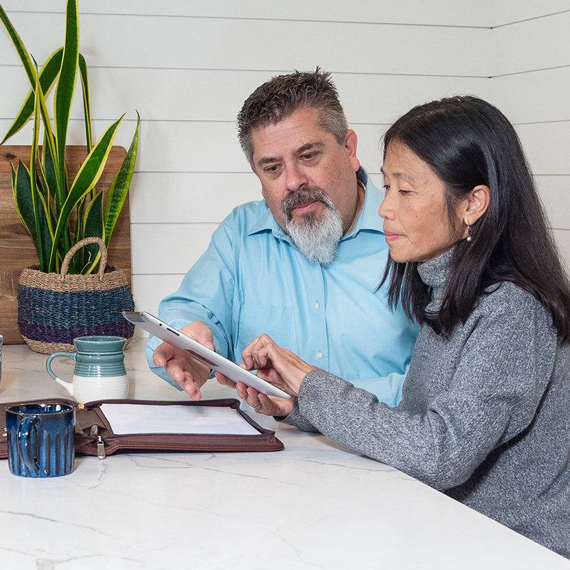 A married couple reads about payment protection while applying for a loan