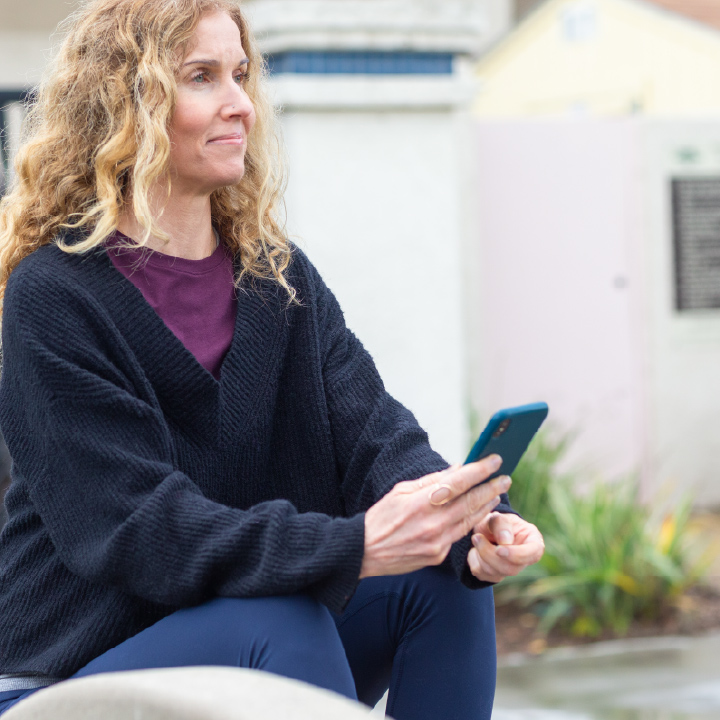 Woman finding condo insurance on her phone