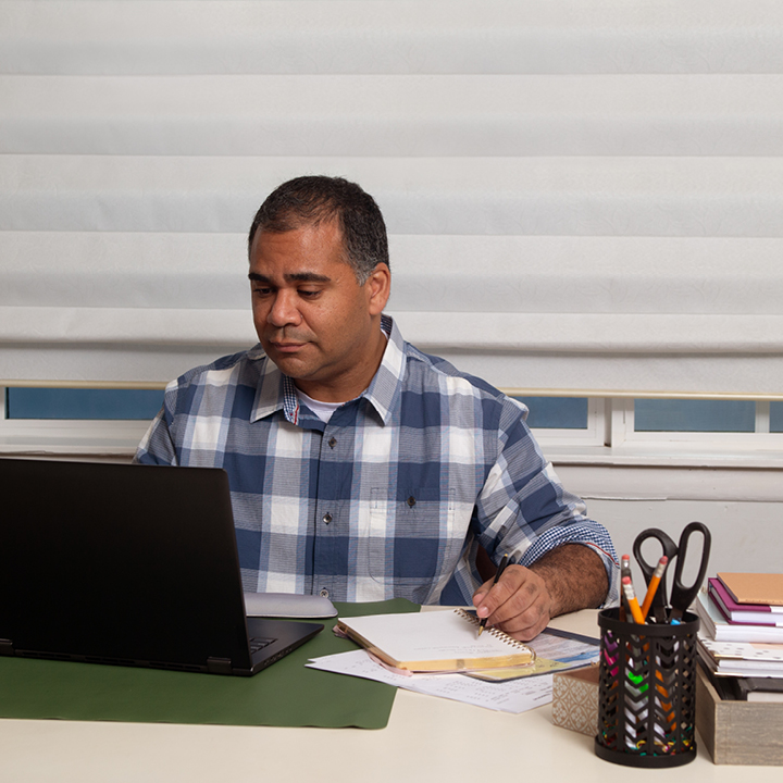 A man looking at annuity information online