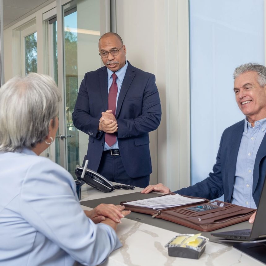 A few people gather to discuss TruStage business solutions