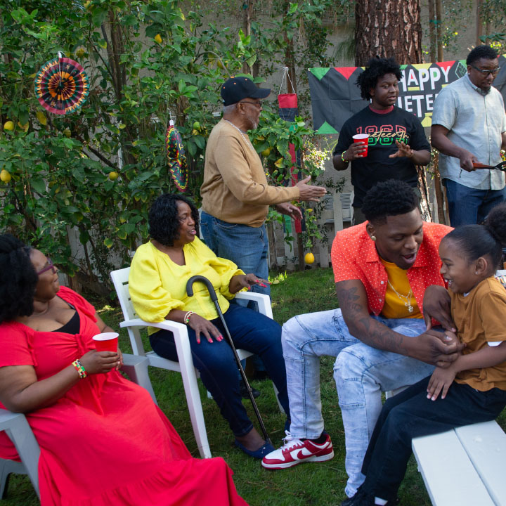 A family gathered outside talking to one another