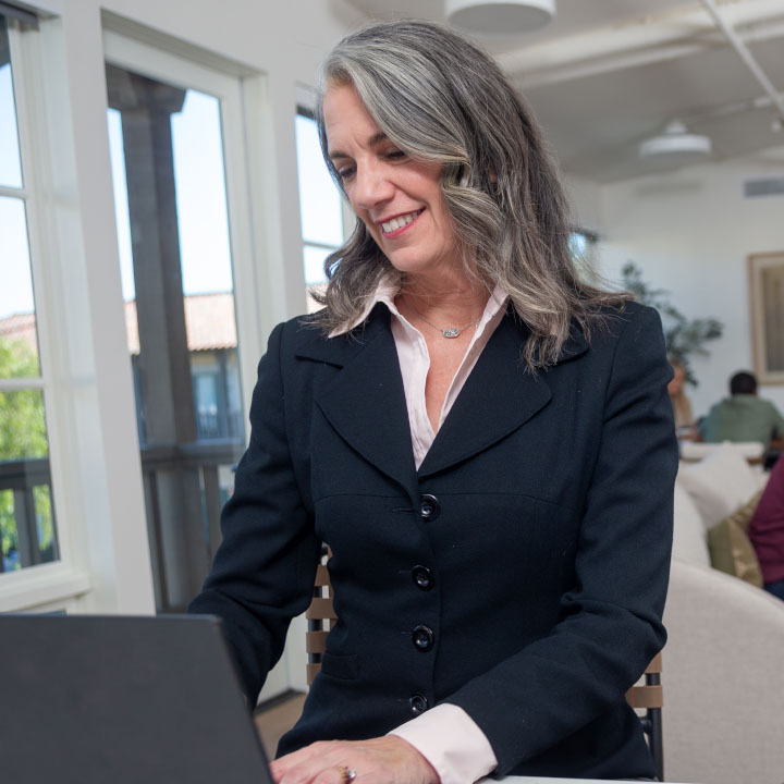A woman using her online account to review her life insurance