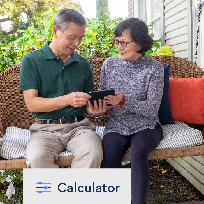 A couple using a life insurance calculator on a tablet