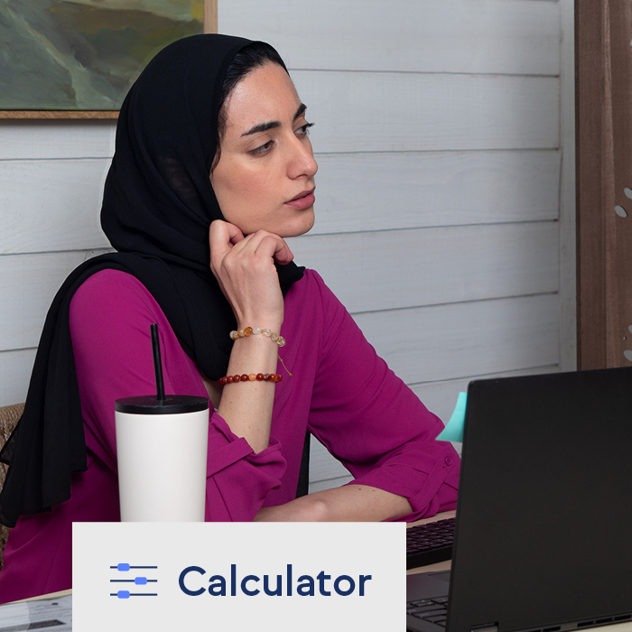A woman using TruStage's loan cost calculator on her laptop