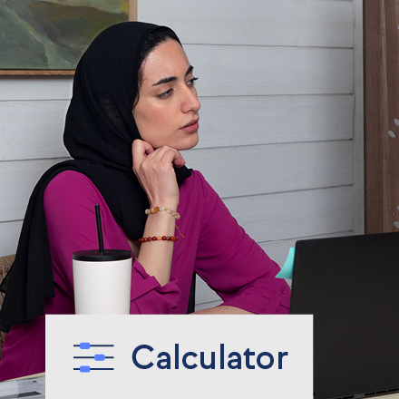 A woman using TruStage's loan cost calculator on her laptop