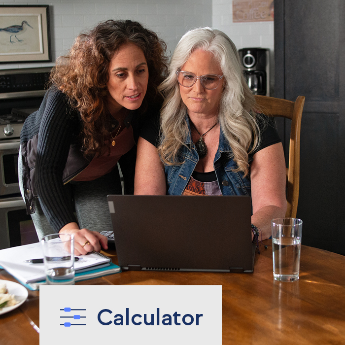 Two women using TruStage's savings goal calculator on a laptop