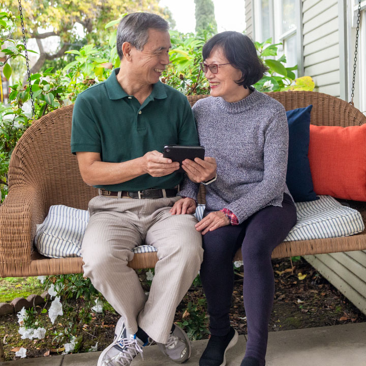 An older couple smiling at each other
