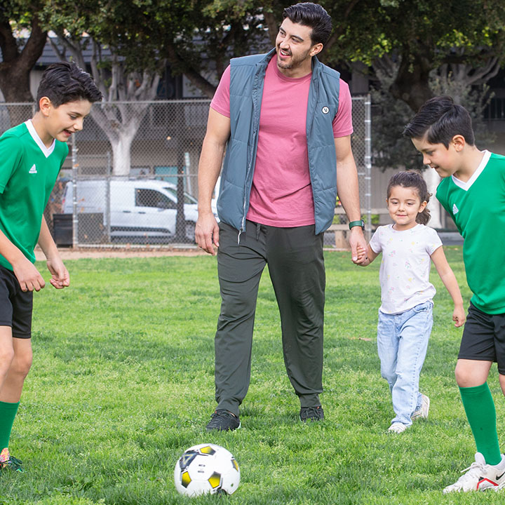 A dad with his kids on a soccer field are better protected by a TruStage Life Insurance policy.