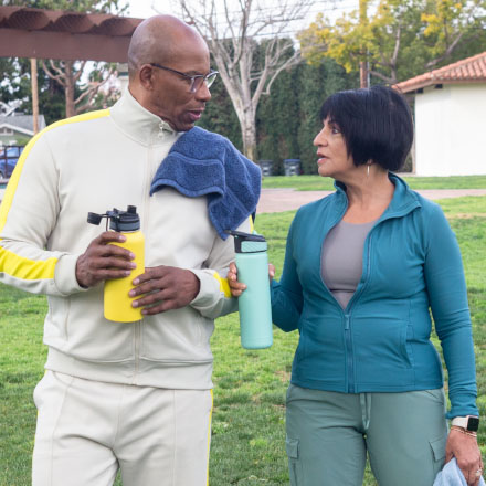A husband and wife talking after they exercised outside