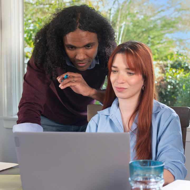 A couple looks at their life insurance policy online