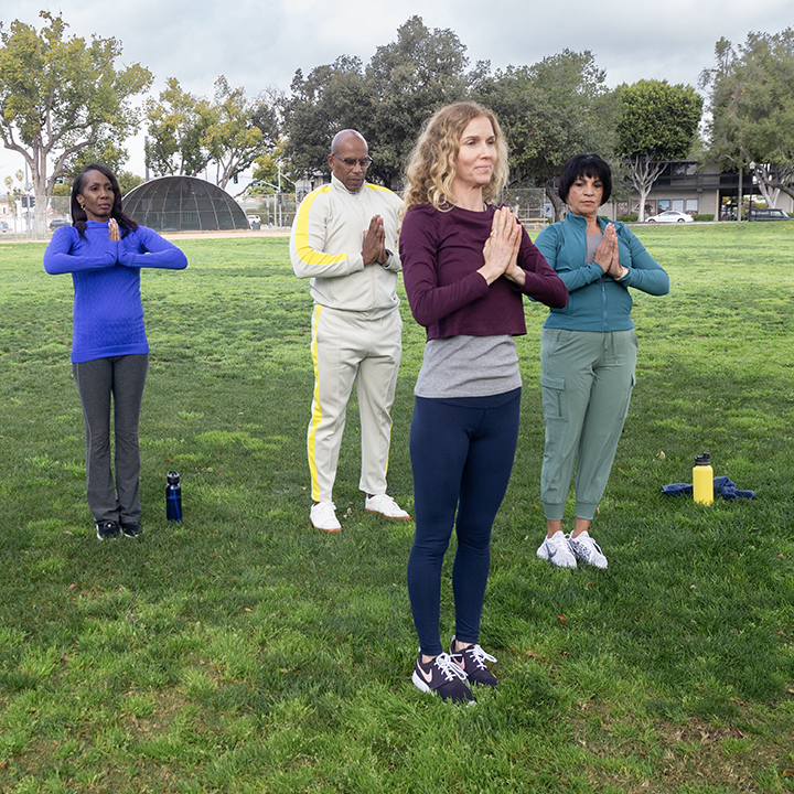 A group of adults working out in a park