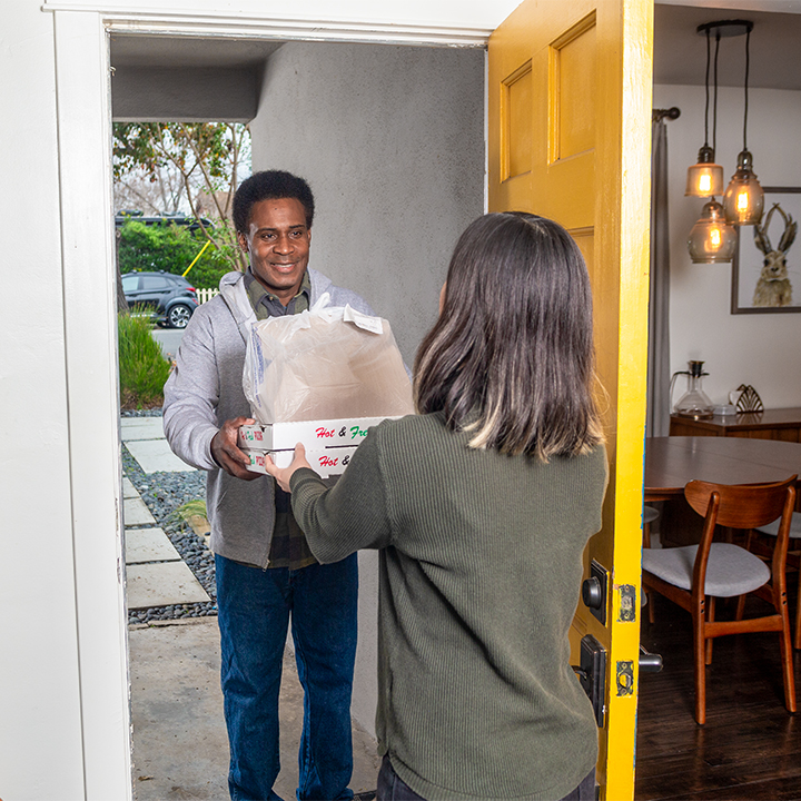 Man delivers pizza to a homeowner