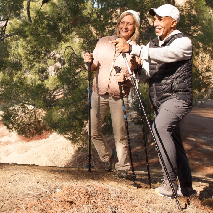 A man and woman discuss how much life insurance is needed while hiking.
