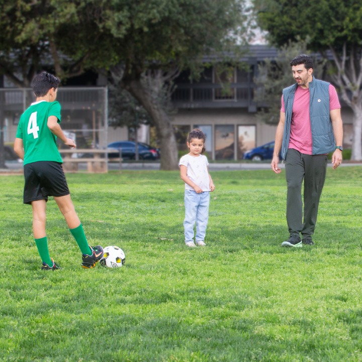 A dad playing soccer with his kids has piece of mind thanks to his TruStage Life Insurance policy.