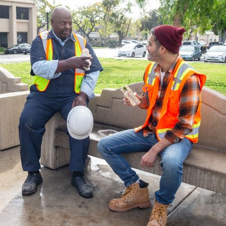 Two constructions workers on lunch break are better protected by TruStage AD&D Insurance.