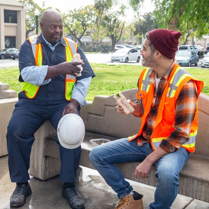 Two constructions workers on lunch break are better protected by TruStage AD&D Insurance