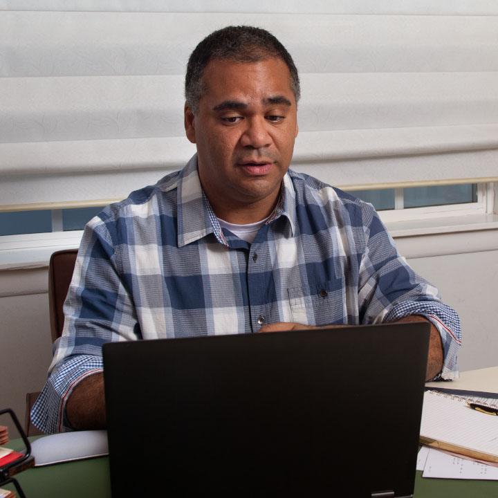 A man reviews his TruStage Insurance application using his laptop